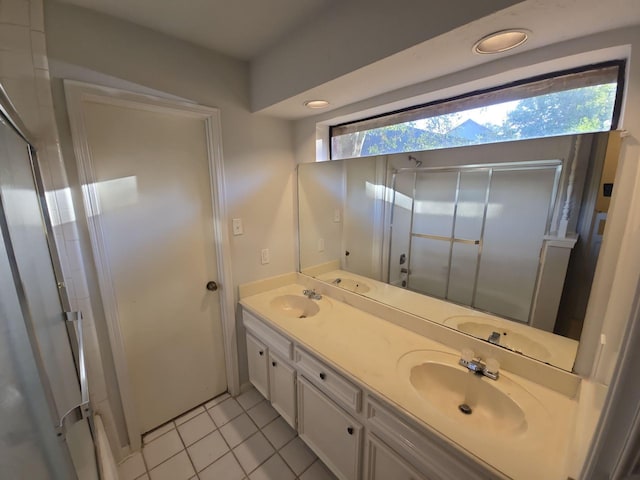 bathroom with tile patterned floors, plenty of natural light, and vanity