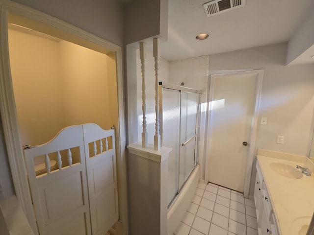 bathroom with tile patterned flooring, vanity, and combined bath / shower with glass door