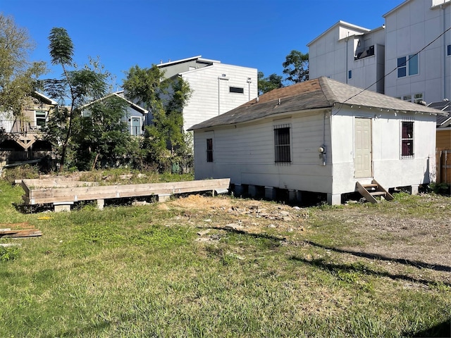 view of side of home with a lawn