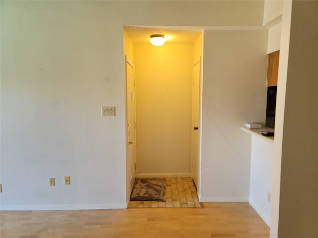 corridor with light wood-type flooring