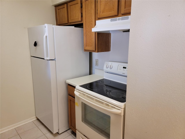 kitchen featuring light tile patterned floors and white appliances