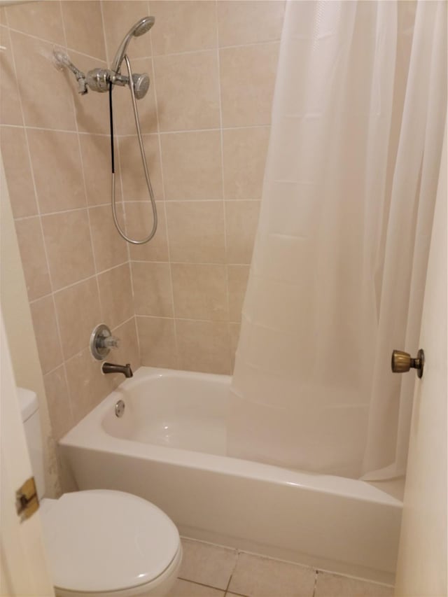 bathroom with tile patterned flooring, shower / bath combination with curtain, and toilet