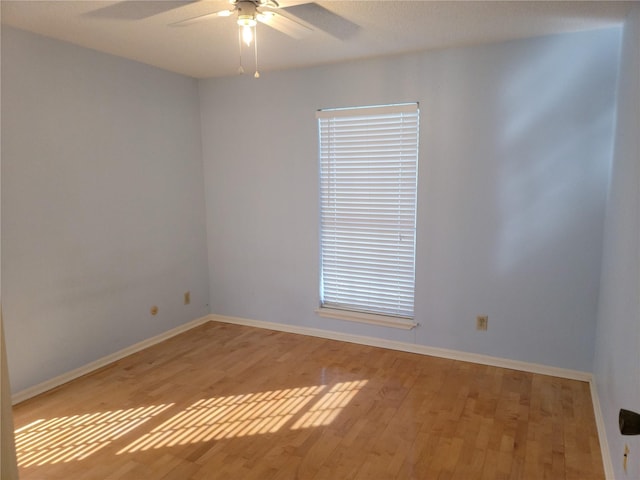 empty room with ceiling fan and light hardwood / wood-style floors