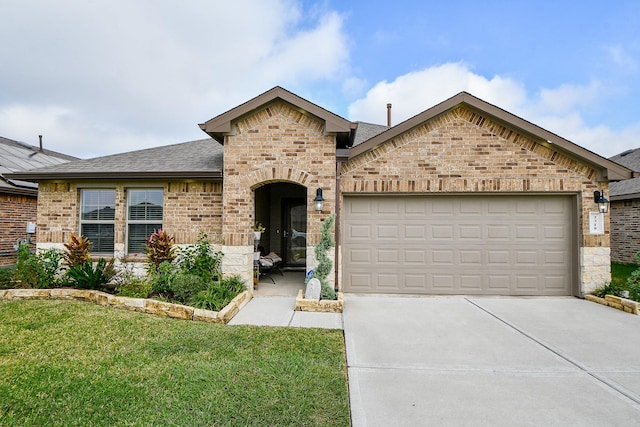 view of front facade with a front lawn and a garage