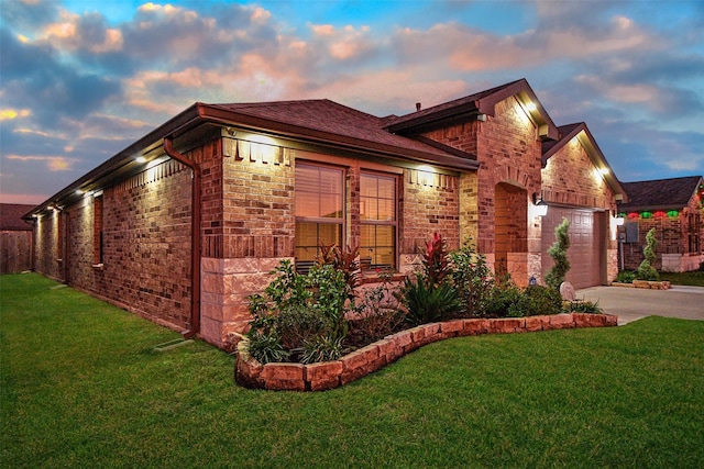 property exterior at dusk featuring a yard and a garage