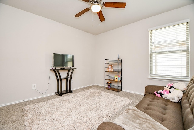 living area with light colored carpet and ceiling fan