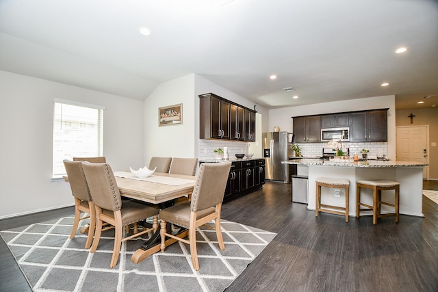 dining room featuring dark hardwood / wood-style flooring and lofted ceiling