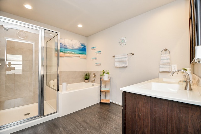 bathroom featuring wood-type flooring, vanity, and independent shower and bath