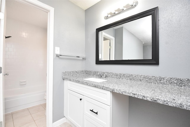 full bathroom featuring toilet, tile patterned flooring, vanity, and tiled shower / bath