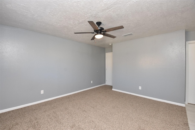 carpeted spare room featuring a textured ceiling and ceiling fan