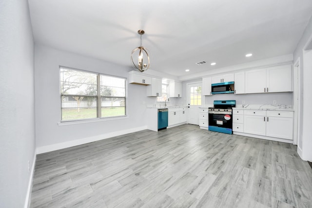 kitchen featuring pendant lighting, stainless steel appliances, white cabinetry, and sink