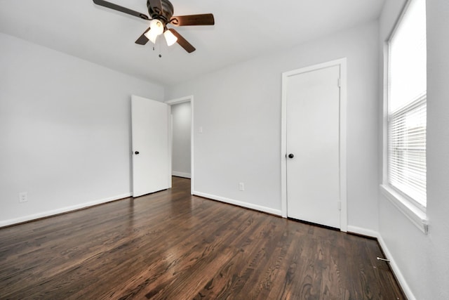 spare room featuring dark hardwood / wood-style floors and ceiling fan