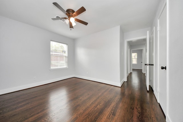 spare room featuring ceiling fan and dark wood-type flooring