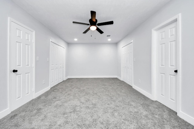 carpeted spare room featuring ceiling fan