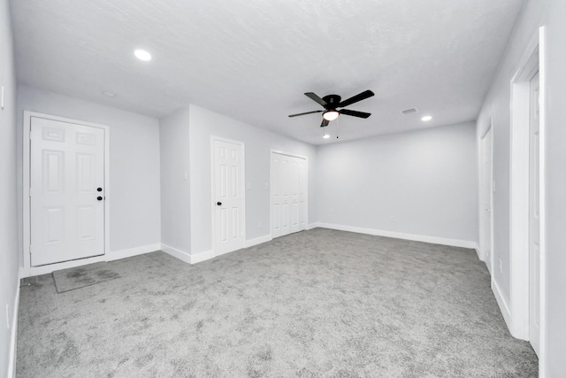 empty room featuring carpet flooring and ceiling fan