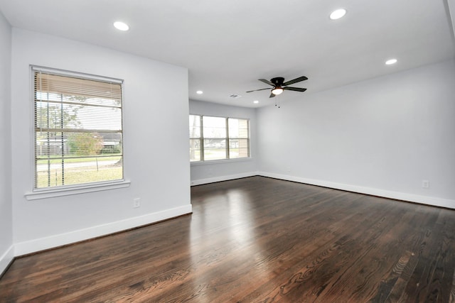 unfurnished room with ceiling fan and dark wood-type flooring