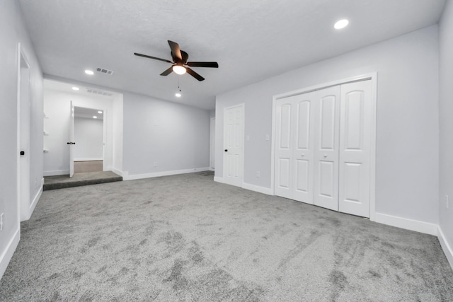 unfurnished bedroom featuring ceiling fan and carpet floors