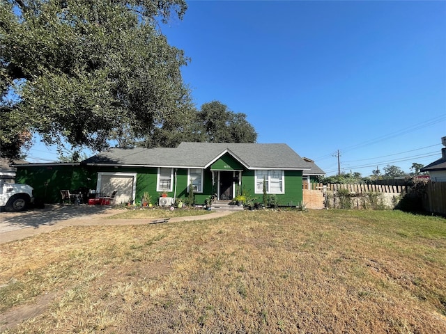 view of front of property with a front yard and a garage