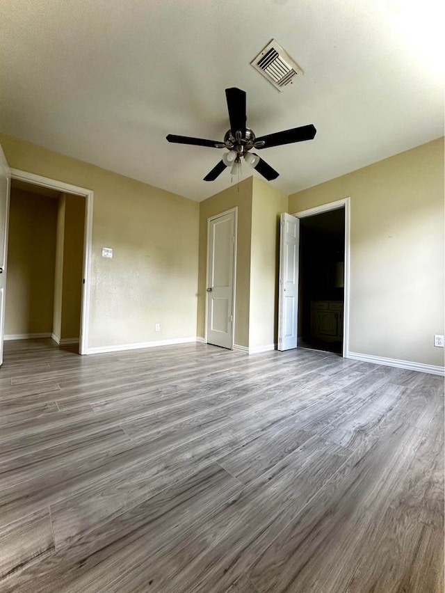 unfurnished room with ceiling fan and light wood-type flooring