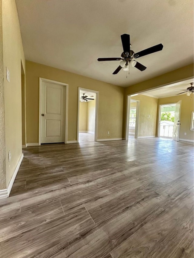 interior space with wood-type flooring and ceiling fan