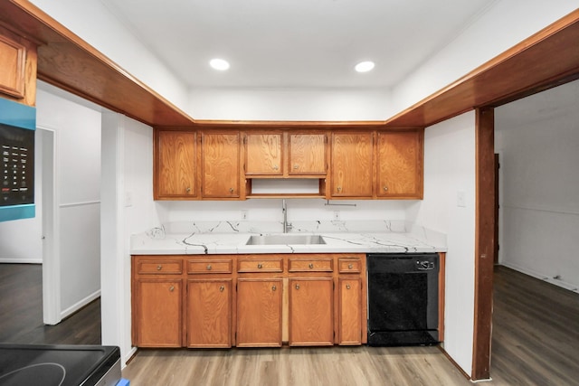 kitchen with black appliances, light hardwood / wood-style floors, and sink