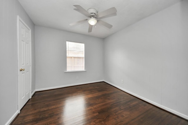 empty room featuring ceiling fan and dark wood-type flooring