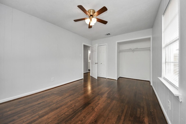 unfurnished bedroom with dark hardwood / wood-style flooring and ceiling fan