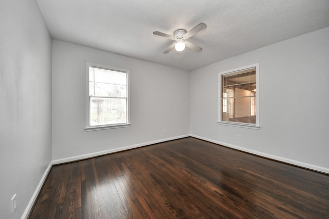 empty room featuring ceiling fan and dark wood-type flooring