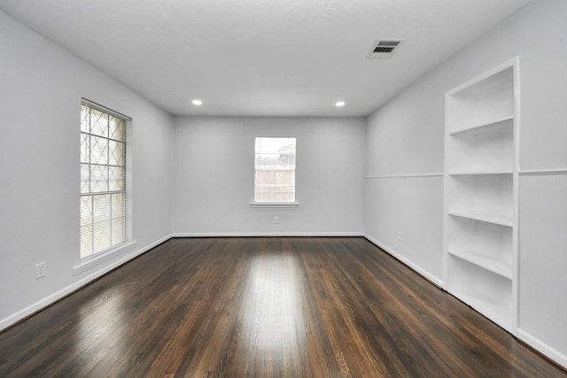 empty room featuring dark hardwood / wood-style flooring