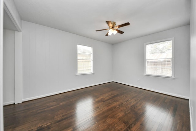 empty room featuring ceiling fan and dark wood-type flooring