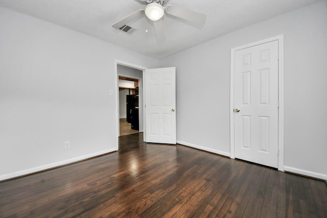 unfurnished bedroom featuring ceiling fan and dark hardwood / wood-style flooring