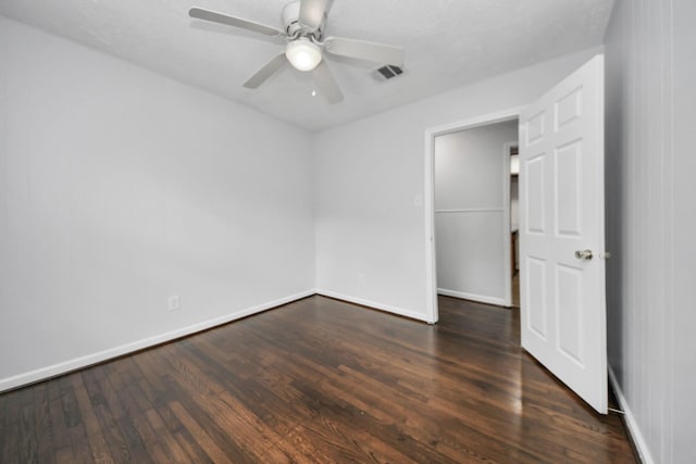 unfurnished room featuring ceiling fan and dark hardwood / wood-style flooring