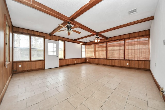 unfurnished sunroom featuring beam ceiling, ceiling fan, and coffered ceiling