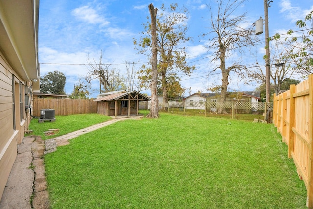 view of yard with an outbuilding and central AC unit