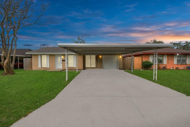 ranch-style home featuring a carport and a yard