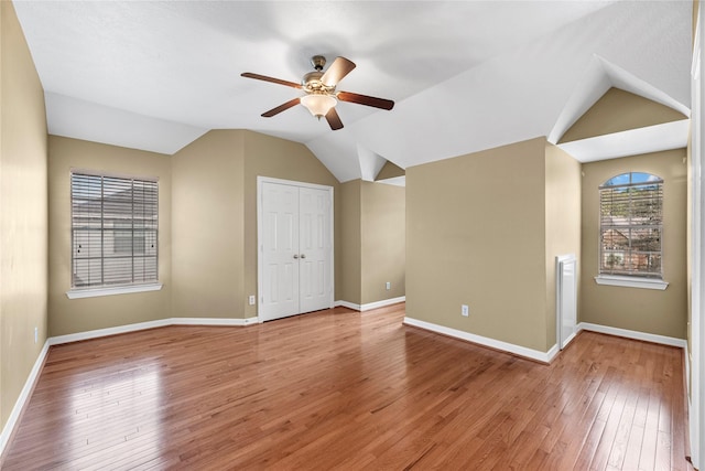 additional living space with ceiling fan, hardwood / wood-style floors, and vaulted ceiling