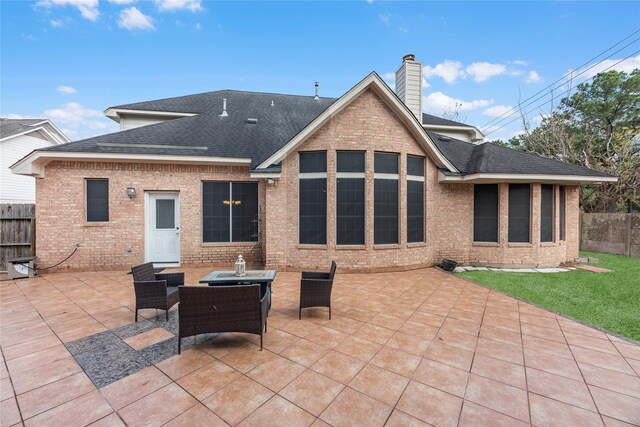 back of house featuring an outdoor living space and a patio