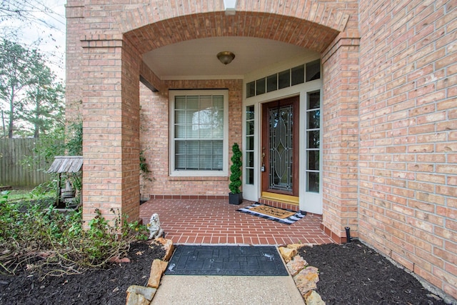 property entrance featuring brick siding