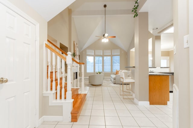 living room featuring ceiling fan, light tile patterned flooring, and lofted ceiling