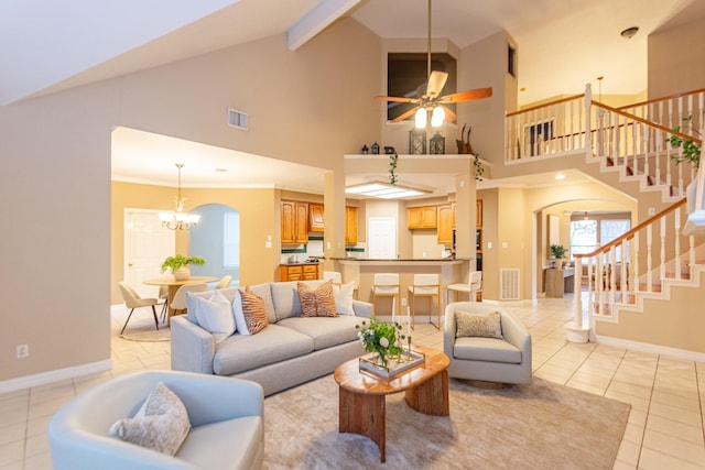 tiled living room featuring high vaulted ceiling, ceiling fan with notable chandelier, and ornamental molding