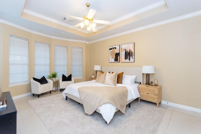 tiled bedroom featuring a raised ceiling, ceiling fan, and ornamental molding