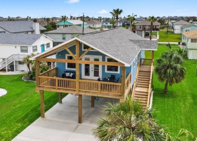 rear view of property with a yard and a carport