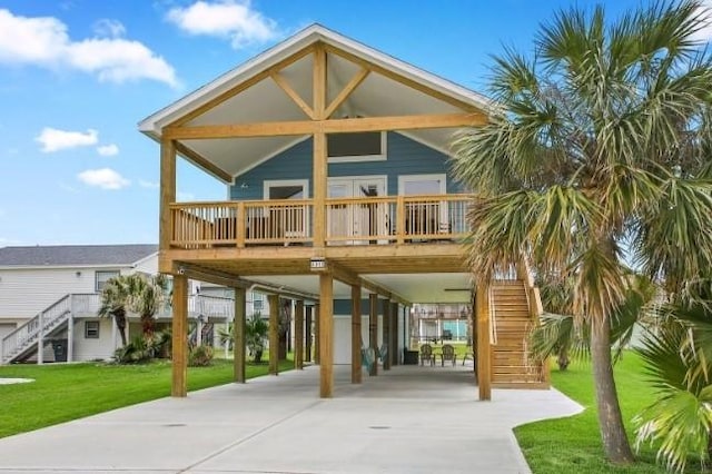 rear view of house with a lawn and a carport