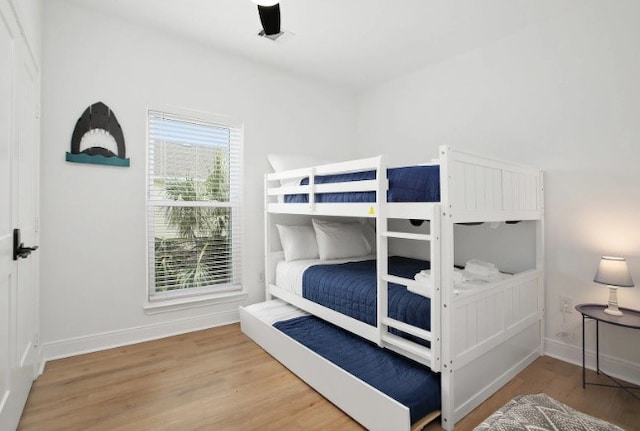 bedroom with ceiling fan and hardwood / wood-style floors