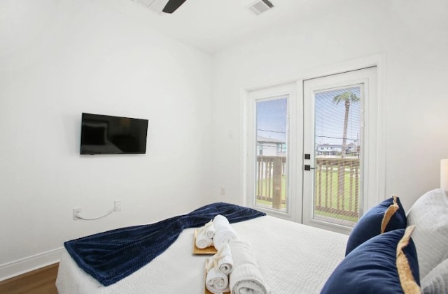 bedroom featuring access to exterior, ceiling fan, and wood-type flooring