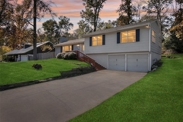 tri-level home with a garage and a yard