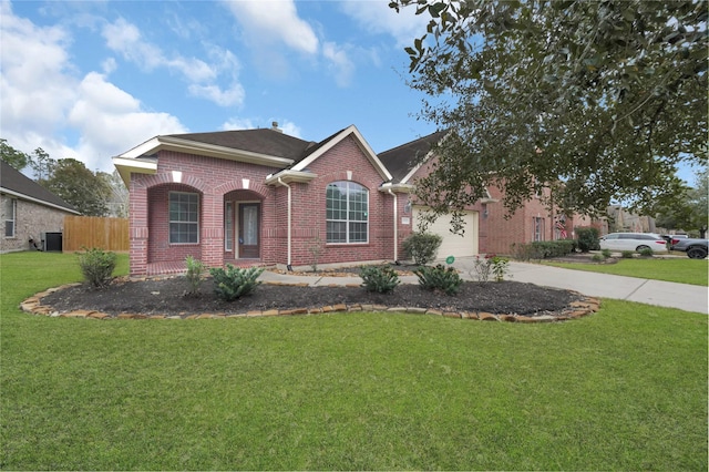 view of front of home featuring central AC, a front yard, and a garage