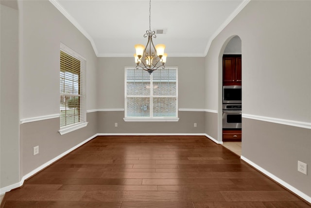 unfurnished dining area with dark hardwood / wood-style flooring, a chandelier, lofted ceiling, and ornamental molding