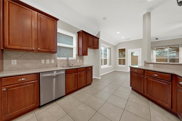 kitchen featuring lofted ceiling, stainless steel dishwasher, crown molding, and sink