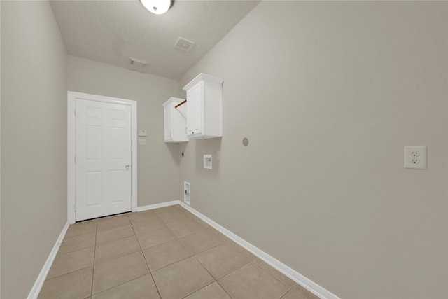 laundry area featuring cabinets, light tile patterned floors, hookup for an electric dryer, and washer hookup